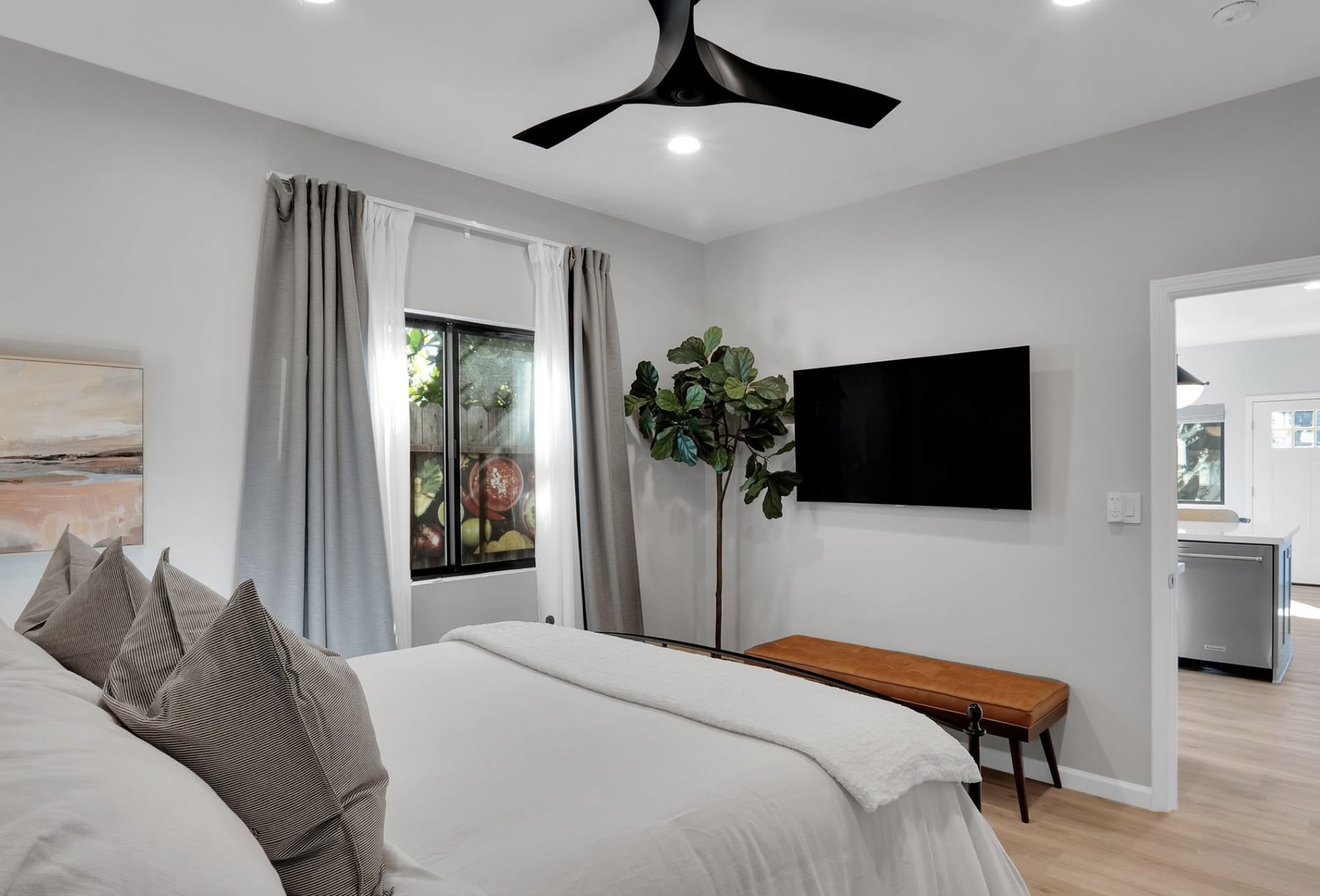 Tenant improvement bedroom with TV and ceiling fan